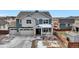 Two-story house with a three-car garage and porch at 1210 Horsetail Loop, Elizabeth, CO 80107