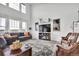 Cozy living room with hardwood floors, large windows, fireplace, and comfortable seating at 1210 Horsetail Loop, Elizabeth, CO 80107