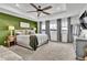 Relaxing main bedroom with green accent wall and ceiling fan at 1210 Horsetail Loop, Elizabeth, CO 80107