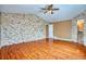 Main bedroom with hardwood floors and stone accent wall at 2320 Flagstaff Dr, Longmont, CO 80504