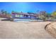 Wide shot of the house showing the exterior elevation and part of the driveway at 778 Suncrest Rd, Palmer Lake, CO 80133