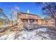 Exterior view of the home with a wooden deck, wood siding and snow on the ground at 778 Suncrest Rd, Palmer Lake, CO 80133