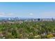 Panoramic aerial view with a distant city skyline and mountains provide an overview of the area at 3560 S Glencoe St, Denver, CO 80237