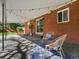 Cozy back porch with string lights, outdoor seating, and a textured rug at 3560 S Glencoe St, Denver, CO 80237