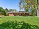 Manicured lawn and mature tree highlight the backyard, offering a serene outdoor experience at 3560 S Glencoe St, Denver, CO 80237