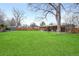 Large backyard featuring a patio, lush lawn, mature trees, and privacy fencing, perfect for outdoor activities at 3560 S Glencoe St, Denver, CO 80237
