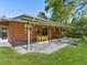 Spacious backyard featuring a covered patio, dining, and well-manicured lawn at 3560 S Glencoe St, Denver, CO 80237