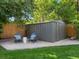 Backyard shed with seating and concrete patio provides extra outdoor storage and relaxation space at 3560 S Glencoe St, Denver, CO 80237