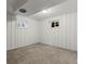 Finished basement bedroom with neutral carpet, white walls, two windows with curtains, and overhead lighting at 3560 S Glencoe St, Denver, CO 80237