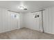 Finished basement bedroom with neutral carpet, white walls, two windows with curtains, and overhead lighting at 3560 S Glencoe St, Denver, CO 80237