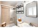 Bright bathroom featuring tiled shower with glass door, open shelving, and marble countertop vanity at 3560 S Glencoe St, Denver, CO 80237
