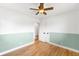 Bright bedroom with two toned paint, wood floors, and a ceiling fan at 3560 S Glencoe St, Denver, CO 80237