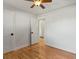 Hardwood bedroom has open door, closet, and white walls with black hardware at 3560 S Glencoe St, Denver, CO 80237