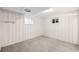 Bedroom featuring neutral carpet, two windows, and white paneled walls at 3560 S Glencoe St, Denver, CO 80237