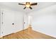 Bright bedroom features an open closet, hardwood floors, and white trim at 3560 S Glencoe St, Denver, CO 80237