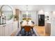 Stylish dining area with wood floors, modern lighting, and built-in cabinets, perfect for Gathering gatherings at 3560 S Glencoe St, Denver, CO 80237