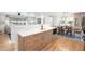 Open dining room with hardwood floors, modern lighting, and a view of the kitchen at 3560 S Glencoe St, Denver, CO 80237