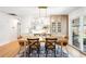 Elegant dining space with hardwood floors, chic lighting, and a seamless transition to outdoor entertaining at 3560 S Glencoe St, Denver, CO 80237