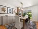 Bright dining room with slider to yard, a modern light fixture, decorative wall art and a stylish sideboard at 3560 S Glencoe St, Denver, CO 80237