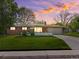 Charming brick ranch home with a well-manicured lawn and a long driveway leading to an attached garage at 3560 S Glencoe St, Denver, CO 80237