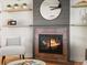 Close up of a cozy fireplace with brick surround, floating shelves, and warm, inviting decor at 3560 S Glencoe St, Denver, CO 80237