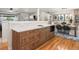 Open concept kitchen featuring a large kitchen island with wooden cabinets and modern appliances at 3560 S Glencoe St, Denver, CO 80237