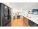 Spacious kitchen features stainless steel appliances, ample counter space, and a large center island at 3560 S Glencoe St, Denver, CO 80237