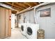 Functional laundry room featuring washer, dryer, sink, and utility connections at 3560 S Glencoe St, Denver, CO 80237
