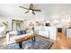Open-concept living room with hardwood floors flowing into the dining and kitchen areas at 3560 S Glencoe St, Denver, CO 80237