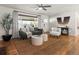 Bright living room features a modern ceiling fan, a comfortable gray sofa and decorative throw pillows, and a jute rug at 3560 S Glencoe St, Denver, CO 80237