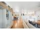 Bright, open-concept living space with hardwood floors, built-in storage, and seamless flow into the dining area at 3560 S Glencoe St, Denver, CO 80237