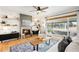 Bright living room featuring a cozy fireplace, hardwood floors, and a large window at 3560 S Glencoe St, Denver, CO 80237