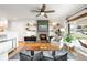 Cozy living room with a brick fireplace, built-in shelves, and a large window at 3560 S Glencoe St, Denver, CO 80237