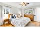 Spacious main bedroom with ample natural light, hardwood floors, and a dresser at 3560 S Glencoe St, Denver, CO 80237
