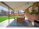 Charming covered patio featuring a dining area, stylish seating, and views of the landscaped backyard at 3560 S Glencoe St, Denver, CO 80237