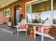 Cozy front porch with seating, decorative pillows, and a charming entrance to this inviting home at 3560 S Glencoe St, Denver, CO 80237