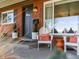 Cozy front porch with seating, decorative pillows, and a charming entrance to this inviting home at 3560 S Glencoe St, Denver, CO 80237