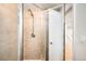 Tiled shower featuring glass doors, modern fixtures, and access to the next room at 3560 S Glencoe St, Denver, CO 80237