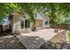 Secluded backyard featuring a stamped concrete patio, lush landscaping, and convenient access to the house at 6230 Snowberry Ave, Firestone, CO 80504