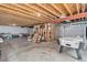 Unfinished basement with exposed wood and concrete floors at 6230 Snowberry Ave, Firestone, CO 80504