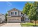 Charming two-story home with a well-maintained lawn and a two car garage at 6230 Snowberry Ave, Firestone, CO 80504