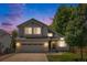 Charming two-story home with a well-maintained lawn and a two car garage at 6230 Snowberry Ave, Firestone, CO 80504