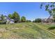 Picturesque green space with walking path provides serene views for neighborhood residents at 6230 Snowberry Ave, Firestone, CO 80504