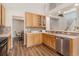 Well-lit kitchen featuring wood cabinets, stainless steel appliances and tile backsplash at 6230 Snowberry Ave, Firestone, CO 80504