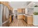 Bright kitchen featuring stainless steel appliances, wood cabinets, and modern countertops at 6230 Snowberry Ave, Firestone, CO 80504