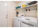 Convenient laundry room with modern appliances and ample shelving for storage at 6230 Snowberry Ave, Firestone, CO 80504