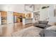 Spacious open concept living room with wood floors, neutral colors, and staircase to the second floor at 6230 Snowberry Ave, Firestone, CO 80504