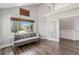 Bright living room featuring wood floors, a gray sofa, and french doors at 6230 Snowberry Ave, Firestone, CO 80504