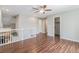 Upstairs loft with wood floors, ceiling fan, and staircase views at 6230 Snowberry Ave, Firestone, CO 80504