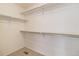 Walk-in closet offers ample storage with built-in shelving and neutral carpeting at 6230 Snowberry Ave, Firestone, CO 80504